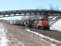 CN 2887 leads CN 2836 through the Halton Sub pulling a mixed load of freight. CN 2944 was midway through pushing as well. All 3 power look like they came from the paint shop. Glencairn Golf course club house peaks through over the top of horizon.