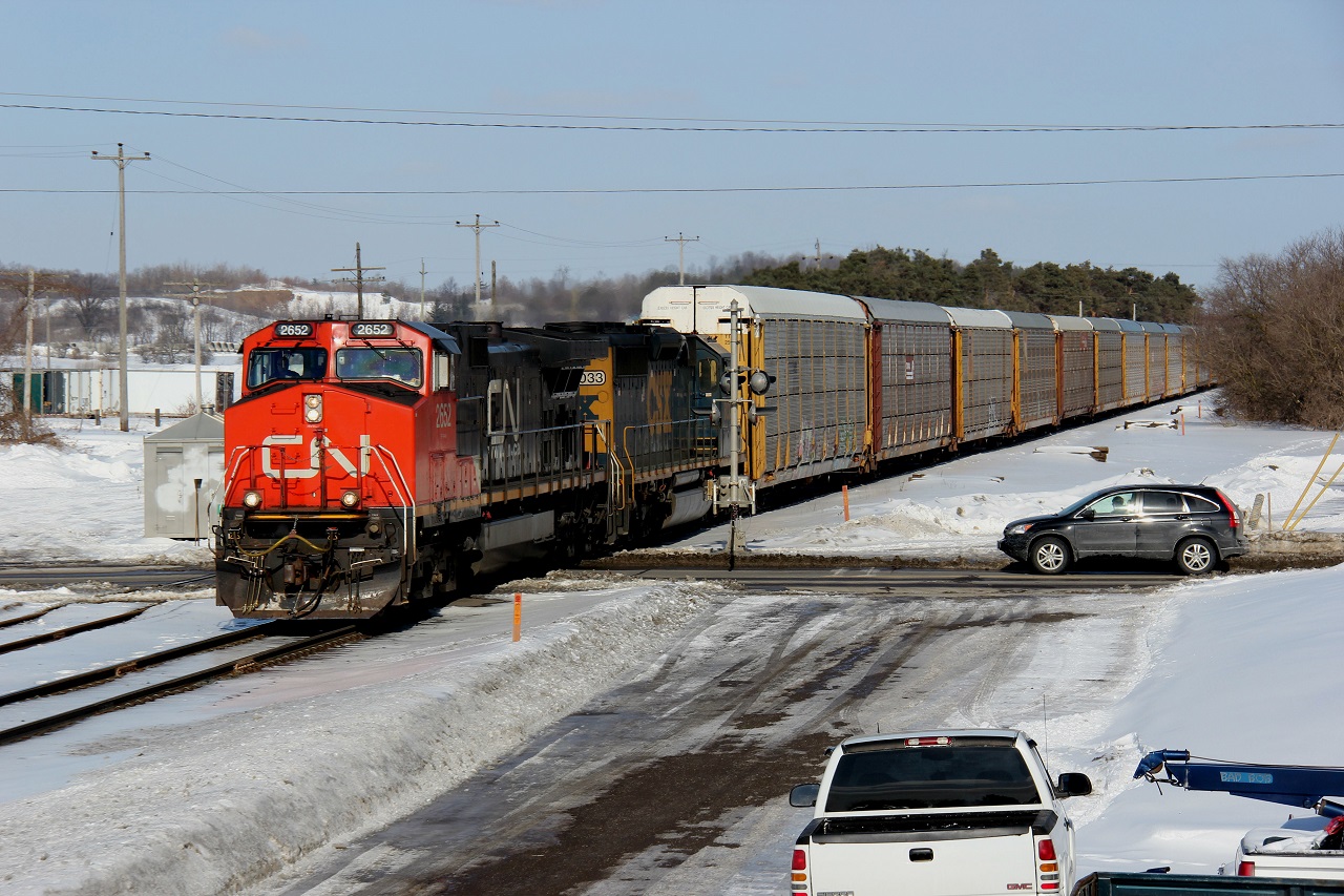 CP 147 makes its way through the town of Ayr with work at Wolverton under sunny March skies, albeit still frigid (most would say unacceptable for this time of year). One good thing about all this snow and cold is the massive piles of hard-packed icy snow that allowed me to get this vantage point. Power is CN 2652 and CSXT 8033 and the time was 14:48. It is nice to see CN leading on CP again, and again with no CP locomotive! Thanks to Curtis for the heads up from the GTA.