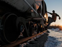 The conductor rides a cut of cars down for a cut.