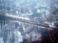 In the endless, perhaps time-wasting, quest for photo locations that no one else could be bothered with, I happened upon the Devil's Punch Bowl in Stoney Creek. Outside chance of a half-decent image here but I had to try it out.  A few days later was in Hamilton and a southbound TH&B was ready to roll from Aberdeen, so off I went. Miserable day. Cold, damp, foggy, and all the rest of it; oddly enough about the same conditions out as I am posting this image 31 years later. Shot a half second too late perhaps, but it was the only time I bothered treking into that spot for a train. TH&B 75, 73, 53 and 57 are seen making the long climb to Vinemount. What do I see? Signals?? A road crossing??? Makes one want to scout this out again come warmer weather and see what remains.