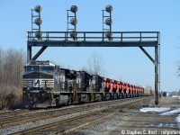 NS H53, with its usual compliment of Canadian crew from the Norfolk Southern St. Thomas (Ontario) division, bring an express delivery of 12 brand new CN GE's fresh from Erie, PA. (See reporting marks for a complete list). Interestingly enough, all but one of these brand new engines are banned from operating into the US owing to Tier 3/4 restrictions that came into effect in 2015, and predictably, one one of these engines was actually idling (CN 2948) the rest were offline. These engines are likely to make the trip to Toronto on CN 422 on or after Monday the 30th of 2015 - consider this a heads up for anyone out and about.<br><br>NS H53 is the last vestige of the Wabash running rights and joint section that once graced Ontario rails between Buffalo and Detroit via St. Thomas. The same men that ran NS 327/8 nearly 10 years ago still operate this train , daily, with a compliment of four crew members: Engineer, Conductor, head end brakeman, tail end brakemen. Why four men? Wabash (Canada) union agreement stipulates when an assignment was permanently abolished, one man (job) is added to what remains in the division and men are bumped into it per seniority. A third man was added to 327/8/369 when NS 344/343 (St. Thomas to Detroit) was abolished in January 2004, and fourth man was added to 369 in January 2007 when 327/8 (St. Thomas to Buffalo) was abolished. Nothing has changed since, thusly the boys of the Wabash still going strong in 2015.