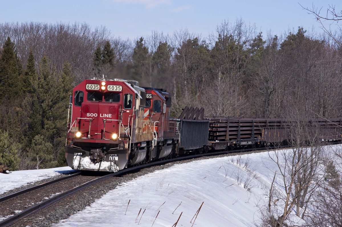 SOO6035-5765 lead a loaded CWR train through Carley.