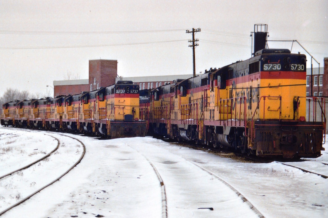 On March 30, 1985 the C&O Canadian operations out of St. Thomas began to shut down when the CASO (Canada Southern) was sold to CN and CP. The C&O was able to abandon its' Windsor-St. Thomas segment and later they ceased operations eastward to Buffalo and only kept the Sarnia Region. This image taken at the C&O main shop area in St. Thomas shows many the GP7s assigned there now dead awaiting disposition. Further input to the whereabouts of these units, the date of the roundhouse/facility demolition and the actual location of the facility would be appreciated. Your scribe's memory has drawn a blank. I have heard that the development slated for this property never materialized and the land, after all these years, is nothing but a crop of weeds. Anyone??