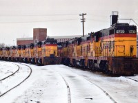On March 30, 1985 the C&O Canadian operations out of St. Thomas began to shut down when the CASO (Canada Southern) was sold to CN and CP. The C&O was able to abandon its' Windsor-St. Thomas segment and later they ceased operations eastward to Buffalo and only kept the Sarnia Region. This image taken at the C&O main shop area in St. Thomas shows many the GP7s assigned there now dead awaiting disposition. Further input to the whereabouts of these units, the date of the roundhouse/facility demolition and the actual location of the facility would be appreciated. Your scribe's memory has drawn a blank. I have heard that the development slated for this property never materialized and the land, after all these years, is nothing but a crop of weeds. Anyone??