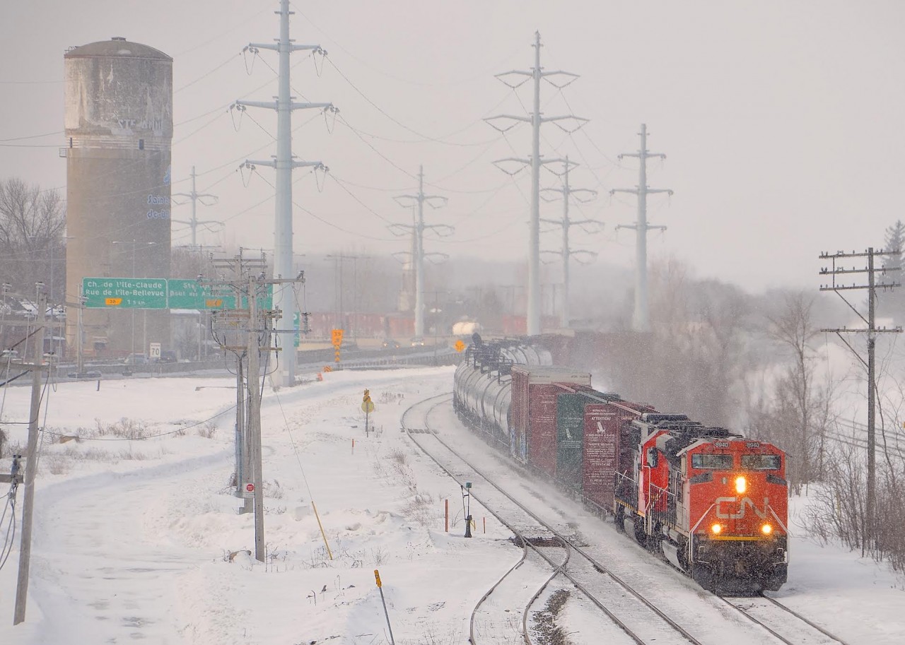 CN 372 with CN 8940 and CN 5449 at the head end rounds a curve just after entering the island of Montreal. CN 2129 is mid-train power on this long train bound for Taschereau Yard in Montreal.