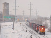 CN 372 with CN 8940 and CN 5449 at the head end rounds a curve just after entering the island of Montreal. CN 2129 is mid-train power on this long train bound for Taschereau Yard in Montreal.