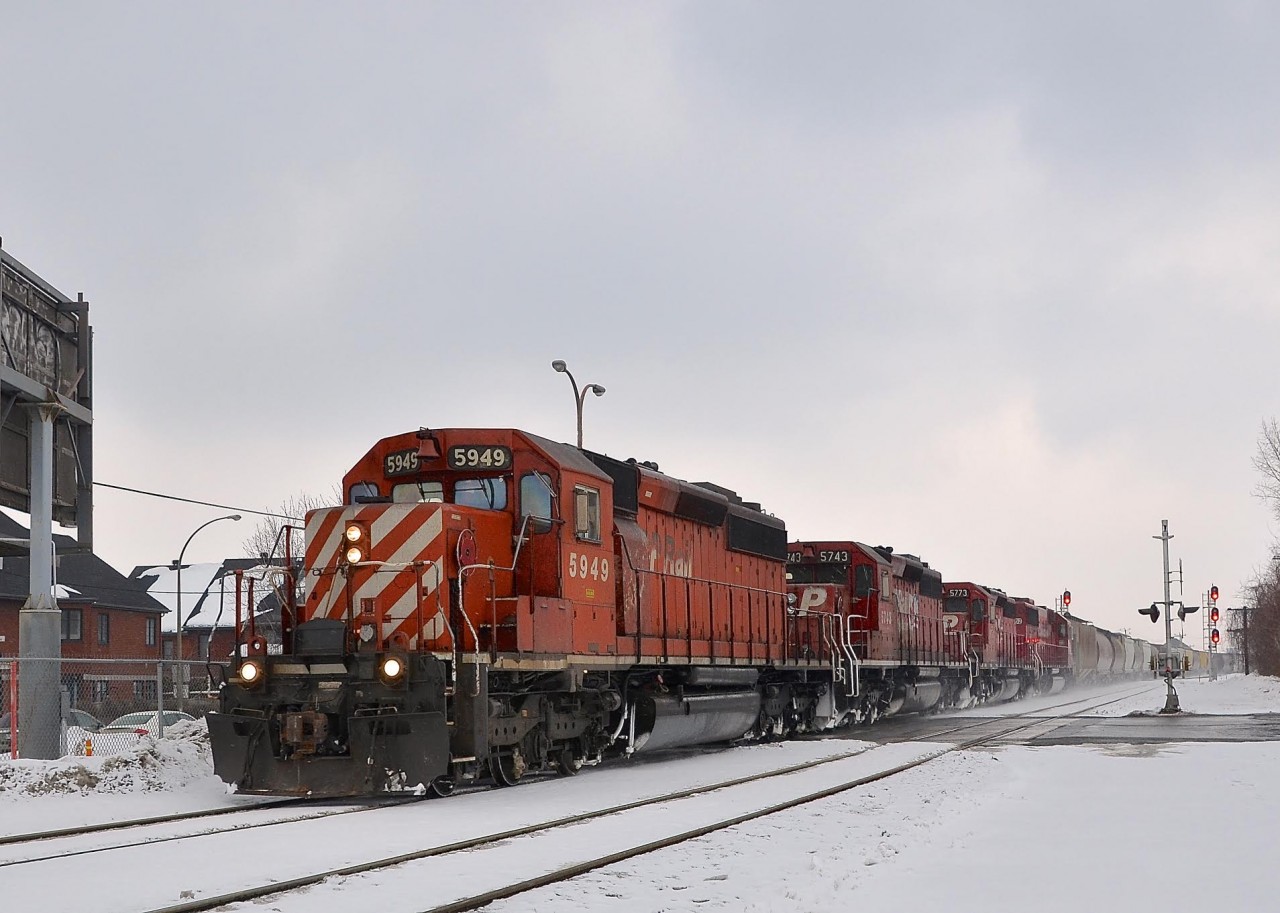 An empty grain train from Quebec City with three CP SD40-2's and an ex-SOO SD60 (CP 5949, CP 5743, CP 5773 & CP 6252) are nearly at the end of their run as they approach St-Luc yard in Montreal. While the train has CP power and is on CP trackage here, it is a Quebec-Gatineau train and crew.