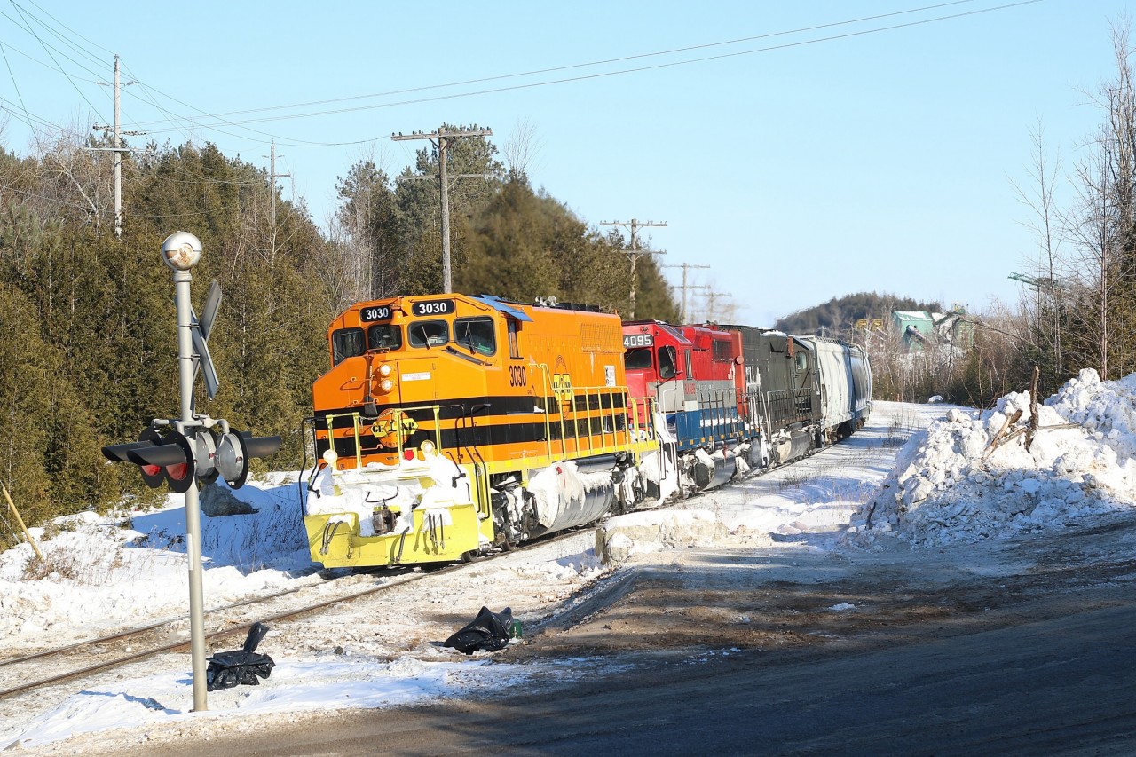 A pair of former CN veteran GP40s lead a former SP Tunnel Motor on the days Stratfond bound road train. The train is passing the once rail served quarry just south of Acton .