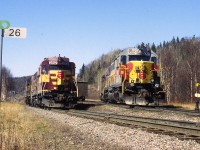 Back when the Wawa sinter plant and the Michipicoten sub still existed, @1998; the scene this day was WC 6590, 6001, 2052 and 2252 brought train of empties to the Harbour, where they were switched out and loads picked up. The power split up; on the right is the empties and the track on the left goes down to the docks. The train will return to Wawa with WC 6001, 6590, 2252 and 2052 in that order. The WC 6001, still in Algoma paint, was formerly the ACR 181. Within the year all this activity would be history. (Mile 26 was the end of the "main".)