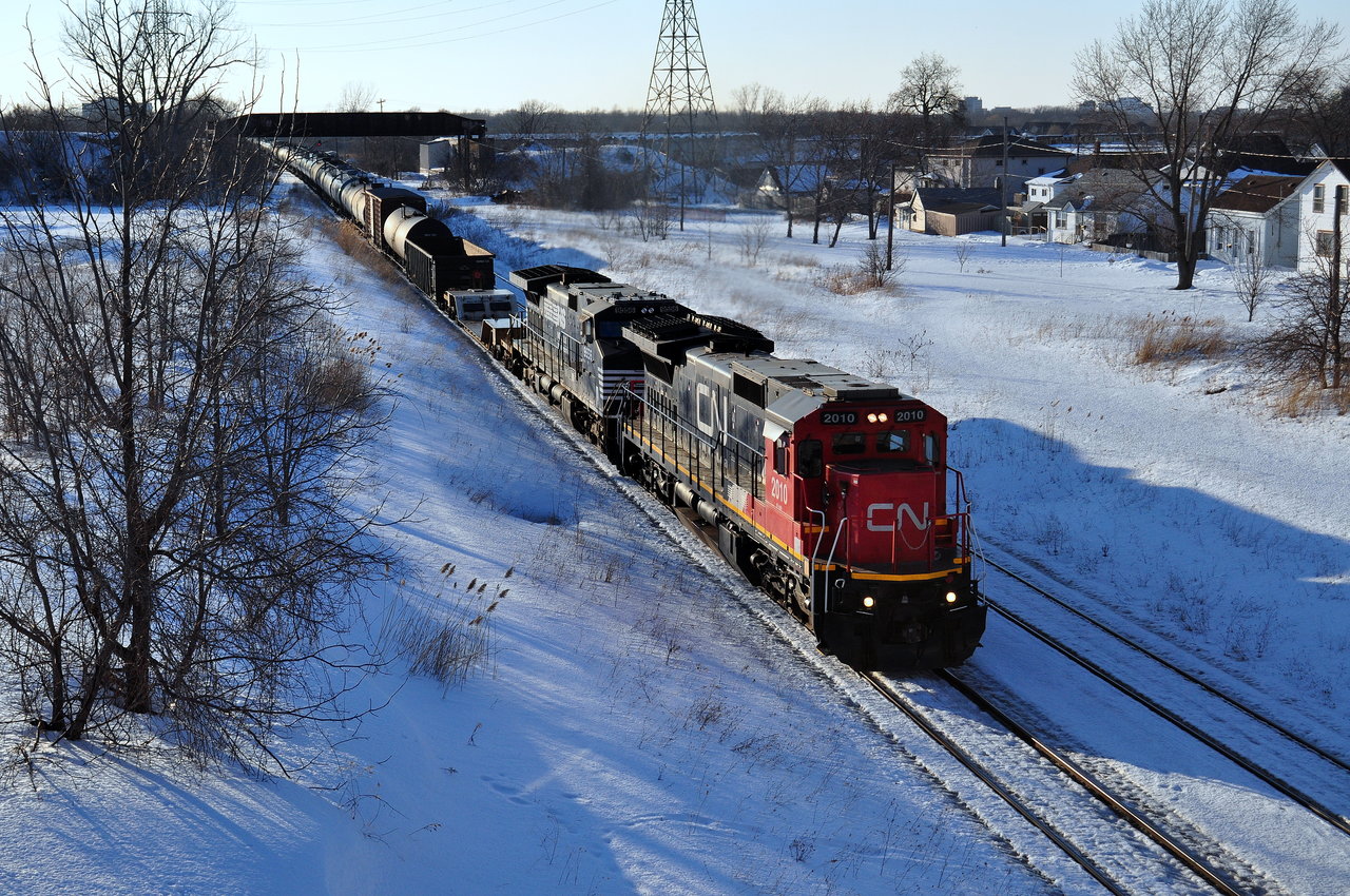 On the first day of Daylights Saving Time, CN 330 makes a rather early appearance through Merriton. 330 has been coming by after dark around 8:30-9:30ish this week so when it rolled by just after 6, it was a nice change. In the background the abandon Townline Spur bridge is visible.