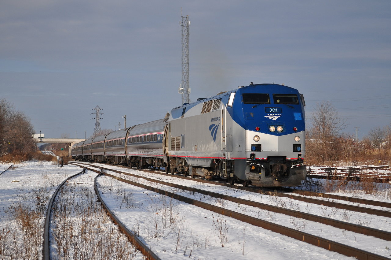 The daily Maple Leaf is slowing down to a halt to wait for the canal bridge to lower. CN 422 is on the other side of the bridge.