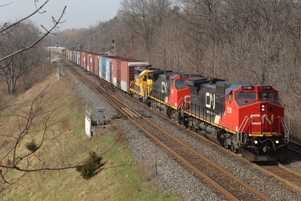 CN 2198 leads CN 2632 and Santa Fe 2514 out of Hamilton and in to Burlington under the RBG Laking Garden walk bridge on a nice sunny spring morning.
