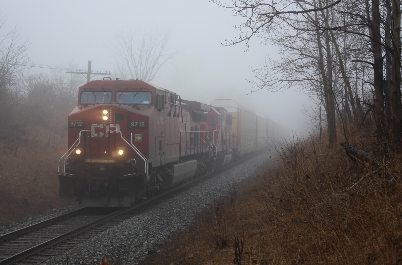 Out of the fog comes CP 9712 leading SOO6044 with Auto racks heading to Wolverton on the daily CP147 run.