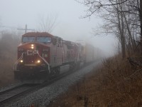 Out of the fog comes CP 9712 leading SOO6044 with Auto racks heading to Wolverton on the daily CP147 run.