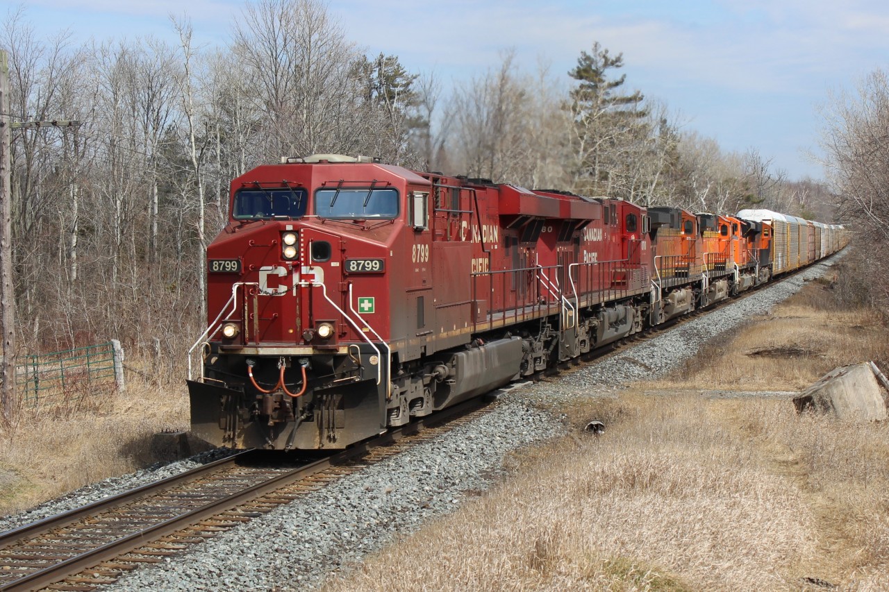 CP 8799 leads CP8780, BNSF5527,BNSF5363,BNSF9097 and BNSF6881 past MM43 on its daily run through Puslinch with auto racks. Clouds parted just in time for a sunny shot.