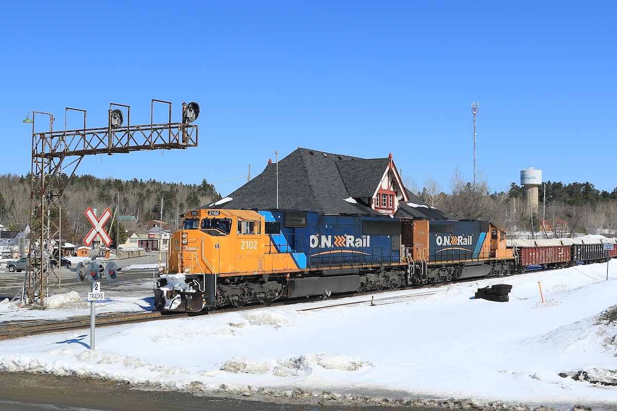 Train 214 is halfway through it's journey from Englehart to North Bay as it passes in front of the station in Temagami.  It's sad that this building no longer welcomes train passengers since the discontinuation of the Northlander in 2012.
