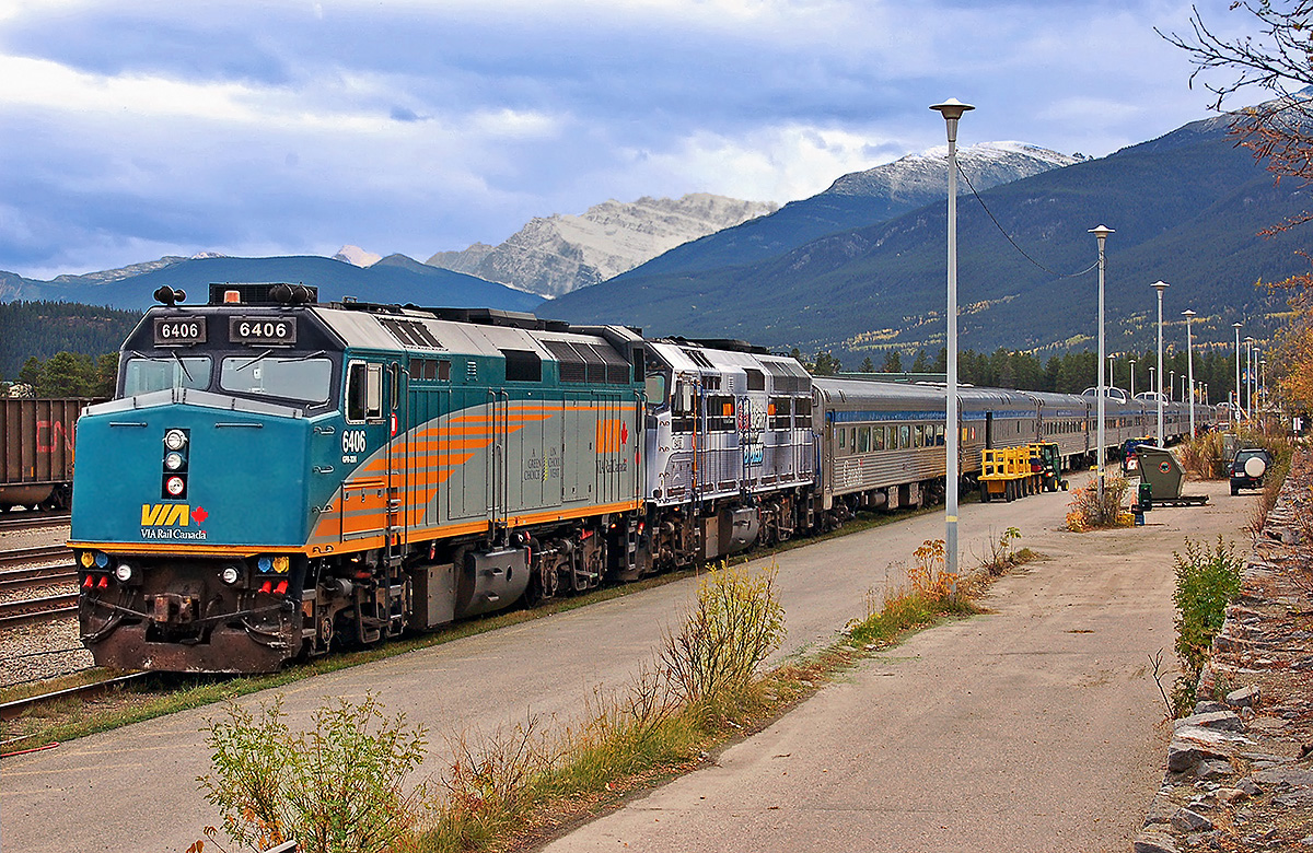 VIA Rail's eastbound Canadian at Jasper, AB. VIA Rail rebuilt F40PH #6406 and Coors Light "Silver Bullet Express" unit #6408 on the point. 

According to VIA Rail’s web page at www.viarail.ca/en , VIA is continuing the service cancellation of the Canadian between Toronto & Winnipeg as a result of the freight train derailment in northern Ontario, with no word as to when the service will be restored. 

While the train is still running between Winnipeg & Vancouver, and Amtrak provides service between Toronto & Vancouver through the United States (see my page on Amtrak’s Empire Builder at http://northamericabyrail.info/usa-west/the-empire-builder/ ), from Toronto it is no longer possible to get to Winnipeg by rail. 

This news is completely unacceptable & comes at a time when it was just announced that forward-thinking politicians in the U.S. have worked together at the state and federal levels to secure funding to repair the rail line through Albuquerque, NM thus preserving Amtrak’s Southwest Chief Chicago to LA passenger rail service: http://krqe.com/2015/03/29/amtrak-says-southwest-chiefs-new-mexico-route-will-remain/

It is to the eternal shame of the Federal Government that they show no interest in providing the meager investment needed to maintain the operation of a viable & important transcontinental rail service, being far more interested with pouring vast amounts of tax dollars into the road & air transport industries. 

VIA provides an essential year-round transportation link to towns & cities across Canada, providing a valuable service to the millions of people who use it every year at a fraction of the government spending given to roads, and with the ability to serve far more city pairs than air ever could.

I would invite those reading this to contact your local political representative or the representatives below urging them to restore the service as soon as possible.  For convenience, you can forward the info I’ve provided on my ‘Why Choose the Train’ page at http://northamericabyrail.info/why-choose-the-train/ to the following recipients:

VIA Rail CEO, Yves Desjardins-Siciliano, yves_desjardins-siciliano@viarail.ca
The Hon. Stephen Harper, Prime Minister of Canada, pm@pm.gc.ca
The Hon. Justin Trudeau, Leader-Liberal Party of Canada, justin.trudeau@parl.gc.ca
The Hon. Thomas Mulcair, Leader-NDP, thomas.mulcair@parl.gc.ca