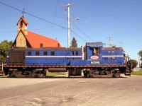 CASCO RS3 NJ 1548 passes St. Pauls Church in Cardinal Ontario, enroute to the starch plant on the waterfront on the spur from CN's Kingston Sub (branches off at Mile 104.59). <br><br> Formerly known as the Canada Starch Company (CASCO), the plant is now "Ingredion Corn Products". They have had a wide variety of switchers over the years, ranging from small GE centre cabs to 70-tonners to Alco switchers, a GMD-1, an MP15AC (currently), and pictured here, their RS3m. <br><br> Originally built by Alco in 1953 as CNJ RS3 1548, it was assimilated into Conrail, who re-engined it with a 1200hp EMD 567 (as CR 9937) under the "DeWitt Geep" program. It went to West Shore Line as their 93 after, and was acquired by dealer Andrew Merrilees, who sold it to CASCO in 2001. Operating with her original number restored as "NJ 1548", the RS3m ran until ex-CN GMD-1 1105 replaced it (acquired from Diesel Electric Services in Sudbury ON in 2007). 1548 was cut up for scrap in 2008.