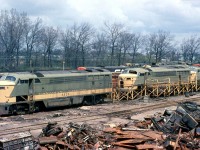 The Canadian National's London Reclamation Yard at London East was the end of the line for a lot of railway equipment for decades, including both steam locomotives and the diesels that replaced them. First generation oddball diesels were typically the first ones retired or traded in by the railways for newer, more modern power. CN's Fairbanks Morse / Canadian Locomotive Company opposed-piston engine fleet built in the 1950's faced an early retirement in the mid-late 60's, and in May 1968 almost a dozen units at the end of their lives are visible in various stages of scrapping. <br><br> Three CLC "Consolidated Line" cab units (C-liners) are visible in the foreground, with CFA16-4 9328 at the head of two other 93xx sisters already missing many components. Visible in the background are a good half-dozen H16-44 roadswitchers, some in the new 1961 "noodle" scheme, but all retired and awaiting the torch.