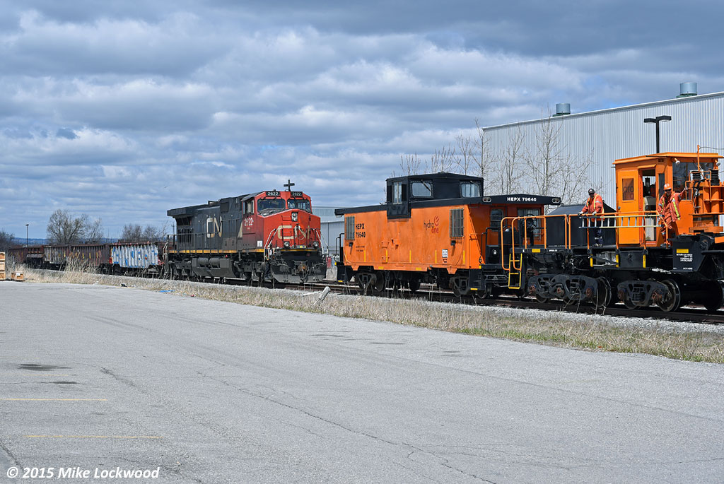 Having arrived at the spur to Ontario Power Generation's Pickering Nuclear generating station, which is a wye, I found it a little odd that the crew chose to run through the west leg of the wye. This necessitated a run around move on the run around track at Clements Road, and I'm sure there was a good reason for this, which allowed for a few shots of the move in a brief period of sun. Still lovin' that van! 1347hrs.