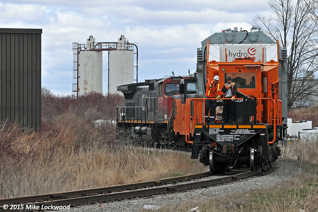 On the curve approaching the entrance to the OPG Pickering compound, HEPX 200 is gingerly eased towards it's final destination. Though it seems odd on the surface to catch a six axle the size of a C44-9W on a seldom used spur, given the weight of the typical shipment on the spur, it's actually pretty appropriate. They even left the buffer gons behind at the run around track a little ways north. 1400hrs.