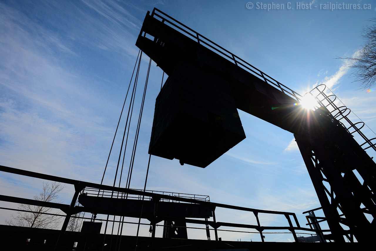 And now for something a little different..  A large counterweight sits in the 'up' position as the former Chesapeake and Ohio ferry dock rusts away in Sarnia. Last used 20 years ago in 1995, other than the rails and ferry dock track which were removed, it sits in place just as it was, along with the Ferry Dock yard office, itself in forelorn condition. Any rp.ca members or viewers have photos from this area in better times? Sign up and submit a photo if you feel up to it!
From what I can tell the Sarnia ferry ran continuously from 1903 to 1995, at the end the ferry was used mostly to transfer over-height cars that could not fit in the tunnel at Windsor. For example, CAMI automotive traffic from Ingersoll would have been routed via CSX to Sarnia/Port Huron via the ferry in the early 90's. With the opening of the CN Tunnel and new haulage agreements, the ferry was no longer needed and closed.