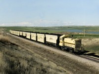 Prairie Coal's SW1001 84160 with southbound coal approaches highway 18 on the 5 mile line from the strip mines south to Sask Power's Poplar River generating station east of Coronach. 