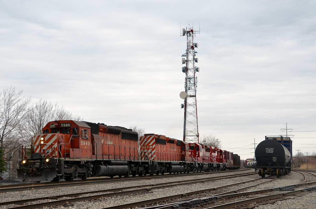 CP 318 for interchange with the CMQ at Iberville heads south through Lasalle with a pair of 36 year old SD40-2's followed by a pair of 2 year old GP20C-ECO's (CP 5949, CP 5919, CP 2276 & CP 2256)