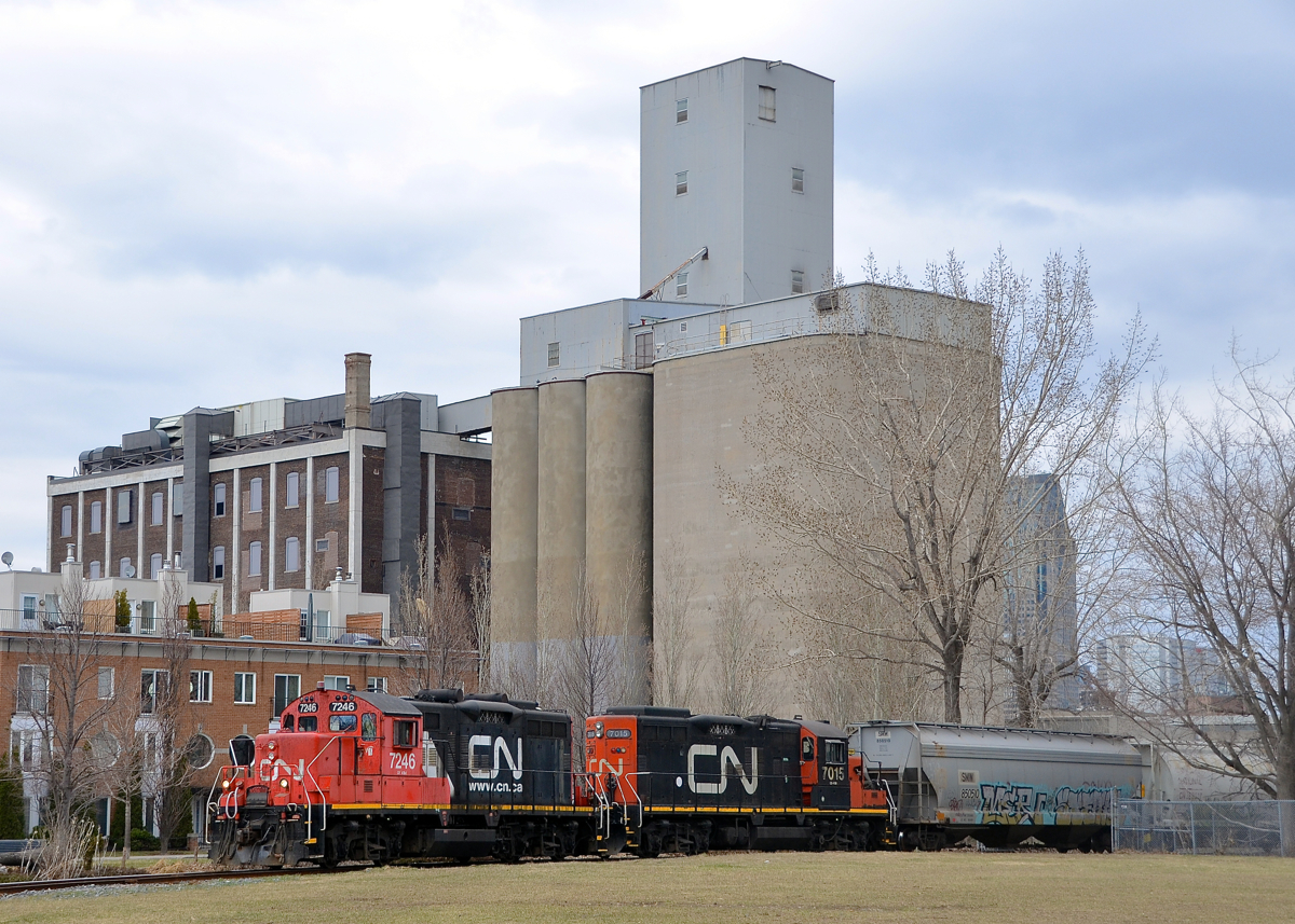 CN 7246 & CN 7015 prepare to leave Robin Hood flour mill with empties on the East Side Canal Bank spur on the north side of the Lachine canal.