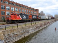 Once Canada's busiest industrial area, the Lachine canal used to be lined with railways on both sides serving numerous industries, like the building here, which was Stelco, and is now condo's. Here a CN switcher with CN 7246 & CN 7015 returns from dropping cars off at Robin Hood Flour mill (visible middle right, behind the trees), the only customer left in this area. 