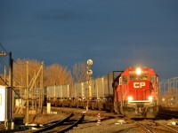 <b>Sun and storm clouds.</b> CP 133 heads through Lachine with a pair of ex-SOO Line SD60's back to back (CP 6252 & CP 6228) not too long after the sun broke through some storm clouds.