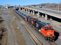 <b>A shiny ES44AC leading.</b> CN 704 is slowly departing Turcot West in Montreal after getting a new crew on a sunny morning. Power is a brand new ES44AC and a somewhat older one (CN 2926 & CN 2879).