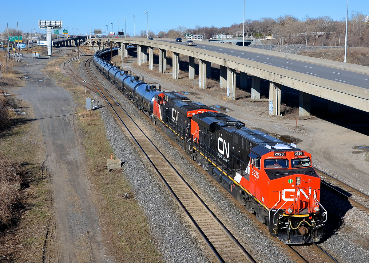 A shiny ES44AC leading. CN 704 is slowly departing Turcot West in Montreal after getting a new crew on a sunny morning. Power is a brand new ES44AC and a somewhat older one (CN 2926 & CN 2879).