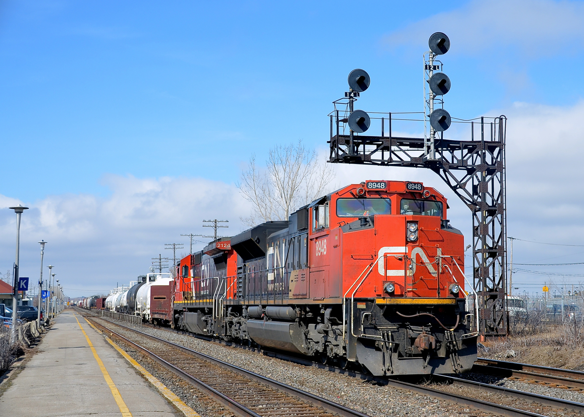 CN 586 is in theory empty TankTrain loads from Maitland, ON, but in practice has lots of non-TankTrain Brockville traffic. Here it passes through Dorval with CN 8948 & CN 2124 on a sunny and warm spring morning.