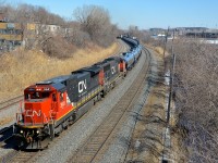 <b>A clean Dash8 leading.</b> CN 705 with oil empties for Alberta has a clean Dash8 leading a ragged looking SD75I (CN 2041 & CN 5737) as it departs Turcot West with 388 axles after a crew change.