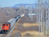 CN 8879 & CN 2673 lead CN 377 around a curve on CN's Kingston Sub in Pointe-Claire on a sunny and warm afternoon.