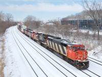 <b>Three zebra cowls and a Dash8.</b> CN 120 has three SD60F's and an ex-ATSF Dash8 (CN 5521, CN 2162, CN 5558 & CN 5508) as it heads east through the Ville St-Pierre neighbourhood of Montreal just as the snow stops falling on an abnormally cold and snowy morning.