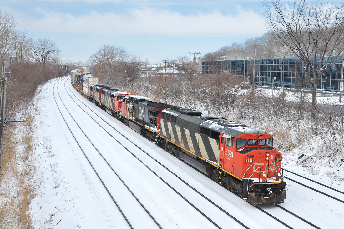Three zebra cowls and a Dash8. CN 120 has three SD60F's and an ex-ATSF Dash8 (CN 5521, CN 2162, CN 5558 & CN 5508) as it heads east through the Ville St-Pierre neighbourhood of Montreal just as the snow stops falling on an abnormally cold and snowy morning.