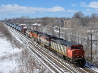 CN 2406, BCOL 4624, BNSF 6382 & BNSF 9804 head east through Pointe-Claire with CN 710.