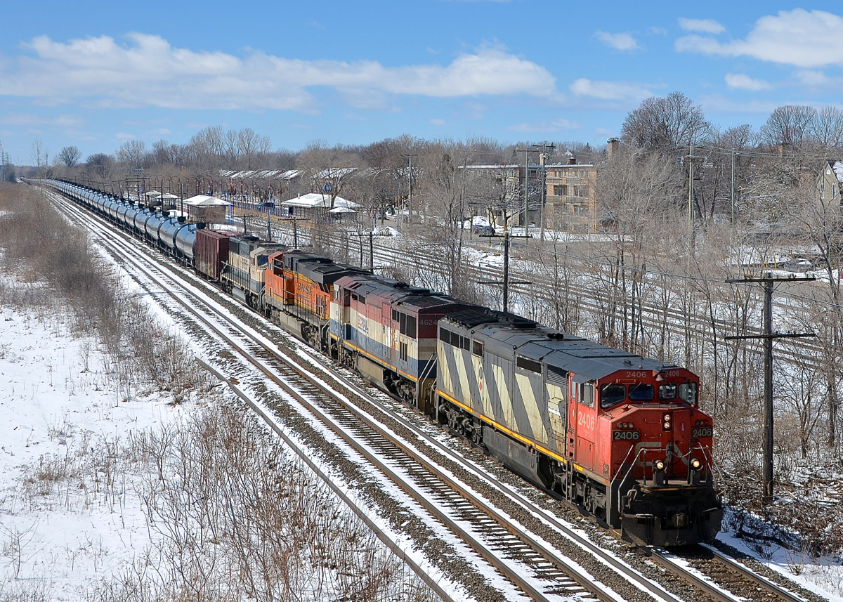 CN 2406, BCOL 4624, BNSF 6382 & BNSF 9804 head east through Pointe-Claire with CN 710.