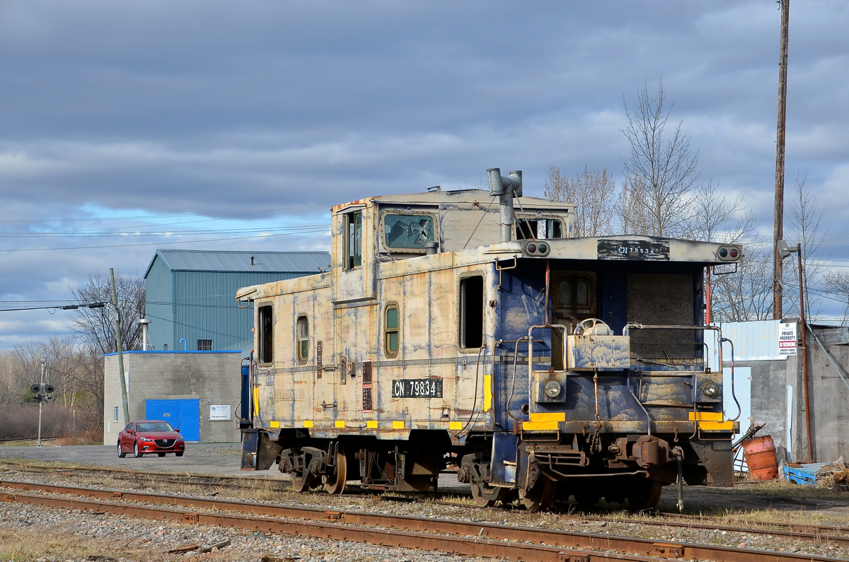 A 'Millenium' caboose in bad shape. CN 79834 is seen stopped in Vankleek Hill on the obscure CN Vankleek Spur. This caboose was built by CN in their Pointe St-Charles shop in Montreal under the same number. CN sold it to the Ontario L'Orignal Railway (OLOR) in 1996, which was taken over by the Ottawa Central Railway. The OLOR named it 'Millenium' for reasons unknown to me. In 2008 CN took over the Ottawa Central and renumbered the caboose back to its CN number. It is used for backup moves on the L'Orignal Spur and is not in good shape.