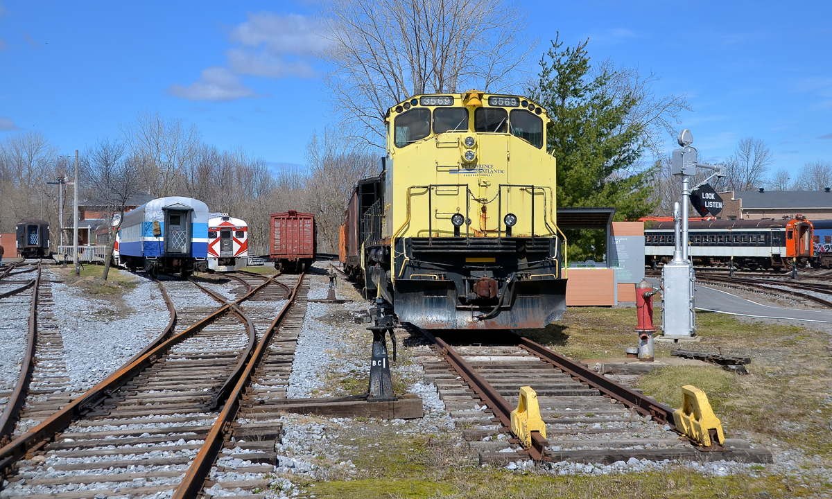 SLQ 3569 and some passenger equipment. SLQ 3569 was built as CN 2569 by Montreal Locomotive Works in 1976 and renumbered to CN 3569 in 1987. It was sold to the St. Lawrence & Atlantic where it kept the same number and they donated it to Exporail where it now resides. Also visible is a number of pieces of passenger equipment, including an ex-AMT car and a pair of CP RDC's at left and an ex-CN MU car at right.