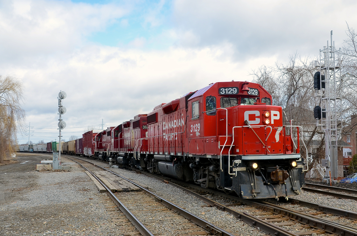 CP 318 has three GP38-2's as it prepares to pass Lasalle station on its way to Iberville and interchange with the CMQ.