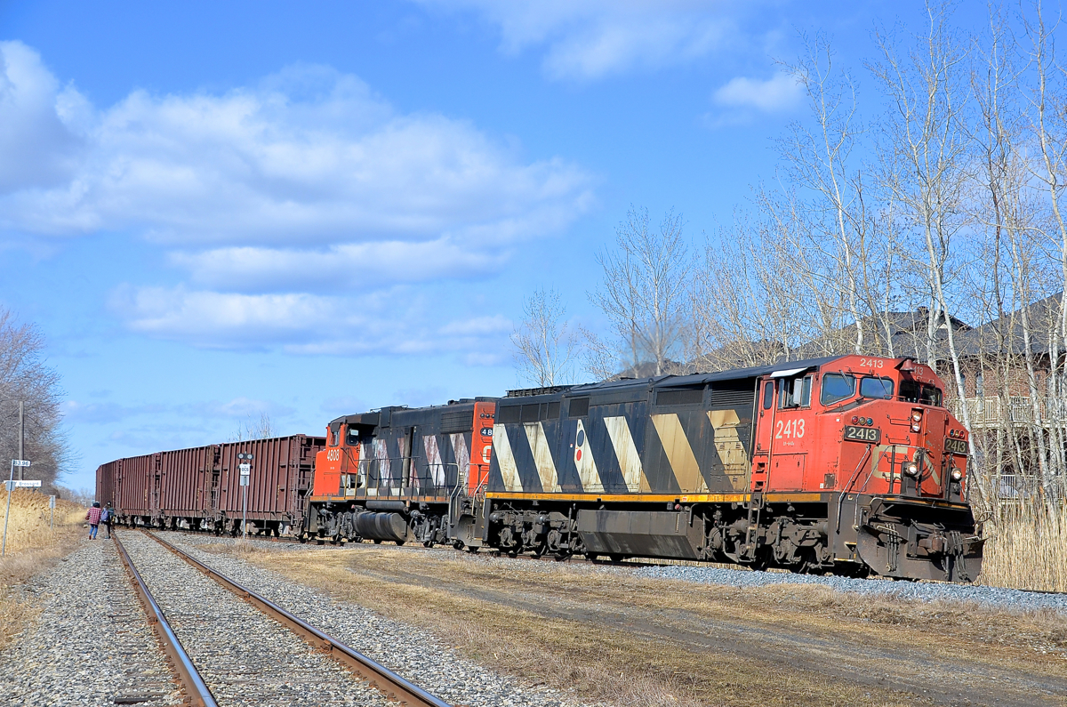 Back on the Rouses Point sub with a pair of Zebras. CN 913 (loaded ballast train) is back on the Rouses Point sub with CN 2413 and CN 4808 after having to back onto the little used Massena spur (at left) to allow CN 323 and CN 522 to proceed northwards. It can now head south and drop ballast on the Rouses Point sub as planned.