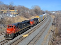 <b>Two types of used Dash8's.</b> CN 401 from Joffre Yard had as power the two Dash8 models that CN bought second hand a few years back (ex-UP Dash8-40C's and ex-BNSF Dash8-40CW's). Here CN 2129 & CN 2147 lead 401 through Montreal West on a spring day (finally). 