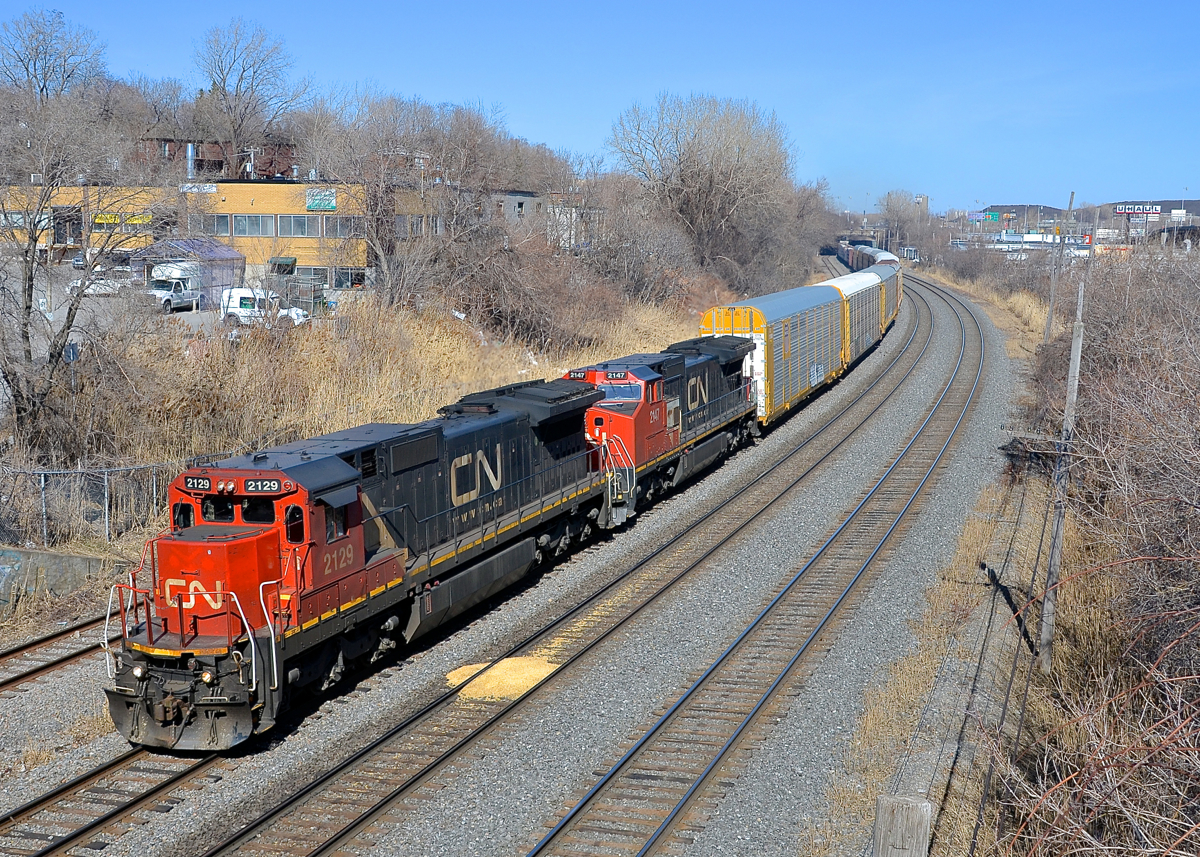 Two types of used Dash8's. CN 401 from Joffre Yard had as power the two Dash8 models that CN bought second hand a few years back (ex-UP Dash8-40C's and ex-BNSF Dash8-40CW's). Here CN 2129 & CN 2147 lead 401 through Montreal West on a spring day (finally).