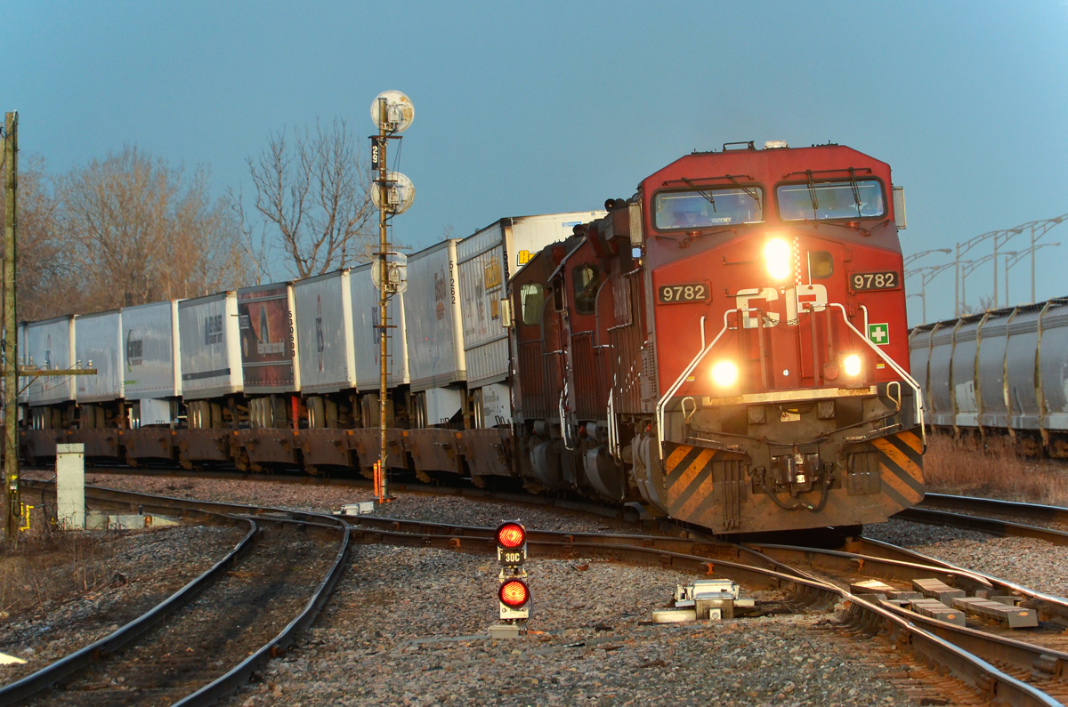 An 'Unstoppable' piggyback train. CP 133, the westbound Expressway (only dedicated piggyback train in Canada) has CP 9782 leading, its plow still striped from when it was in the movie Unstoppable. Trailing are two SD40-2's (CP 6613 & CP 5763) as it heads west through Lachine about half an hour before sunset.