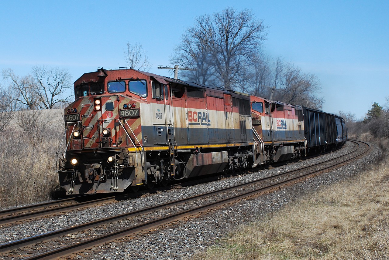 Two tired looking BC Rail C40-8CMs lead 331 around the sweeping curve at MP 19.60 approaching Brantford, ON. Lynden Road once crossed the Dundas Sub. at grade at this location. Thanks for the heads up boys.