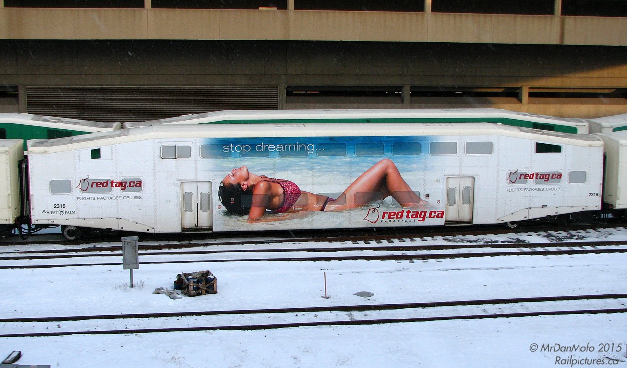 An interesting advertising wrap to spot on a cold winter's morning in February. GO Transit bilevel 2316, one of the usual suspects in the wrap car pool, sports a RedTag.ca Vacations wrap amid the consist of an inbound train arriving at Toronto's Union Station.