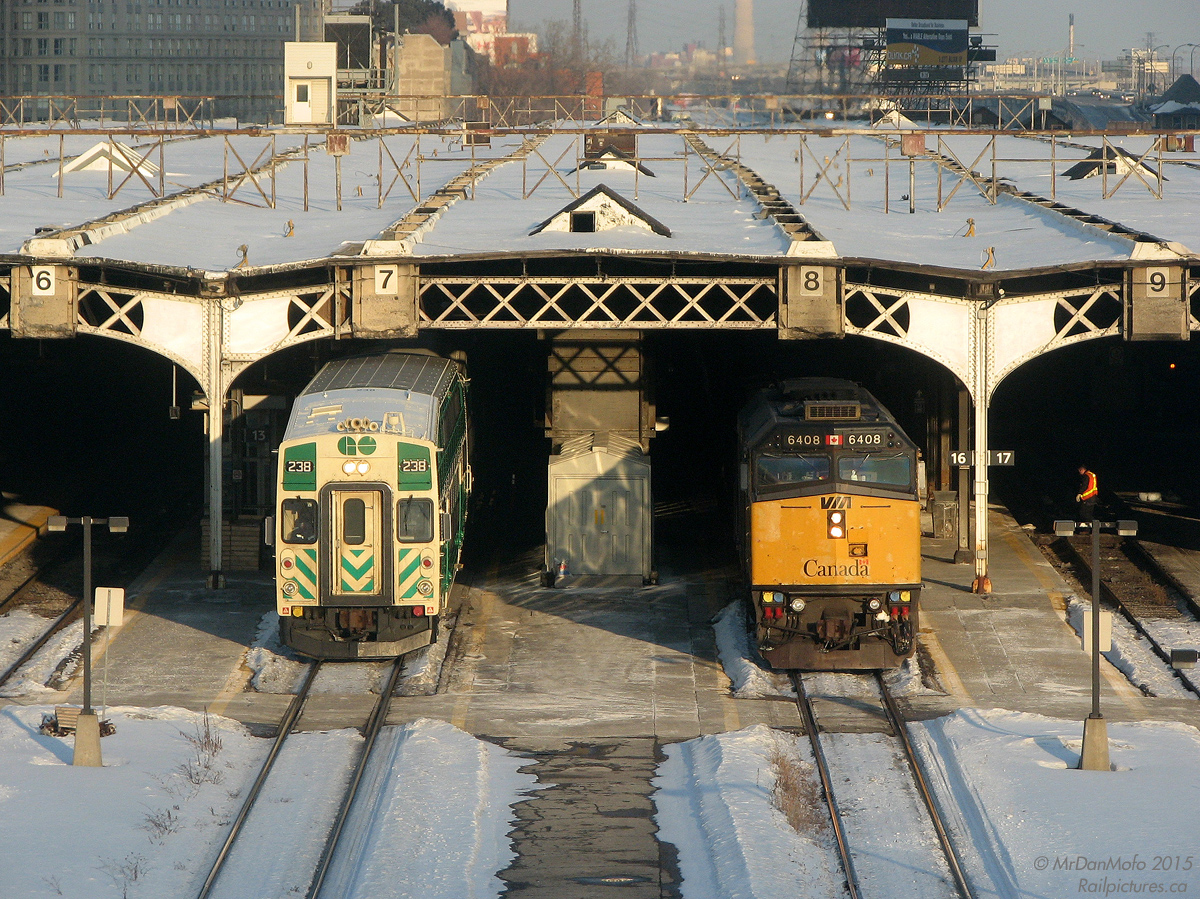 Making its timely 16:30 departure from Toronto with Milton-line GO train #151, GO cab car 238 pulls out of Track 7 of Union Station's train shed (the then-usual track for Milton trains), passing the yellow nose of VIA F40PH-2D 6408 sticking out of Track 8 on train #83, still a good 45 minutes away from its 17:15 departure time.

At this time, it was still dark underneath the 1920's Bush-style train shed - work was still a year or two away from "cubing" it with the giant glass atrium (although some use a far more foul term).